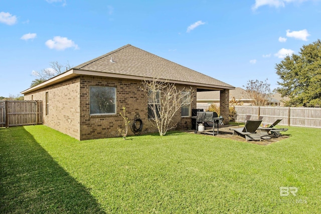 back of property featuring a yard and a patio