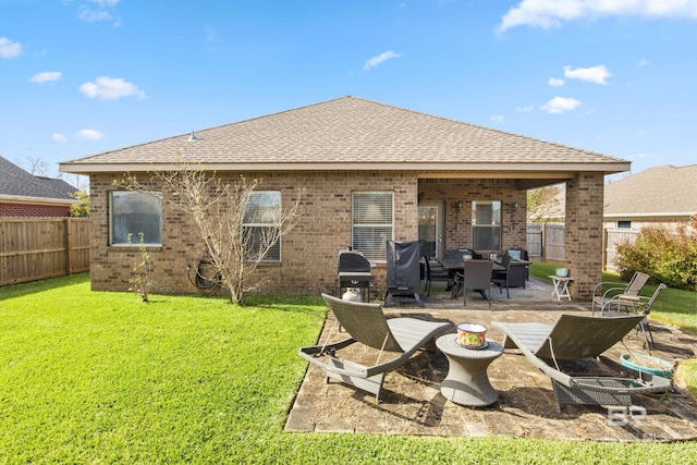 back of property with an outdoor living space, a patio area, and a lawn