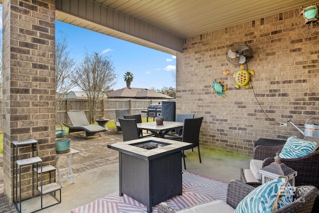 view of patio with a fire pit and area for grilling