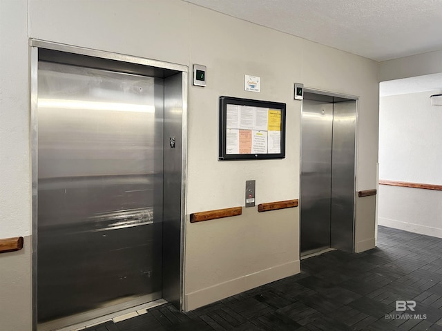 24568 Perdido Beach Blvd Unit 502, Orange Beach, AL 36561 - elevator with baseboards and a textured ceiling