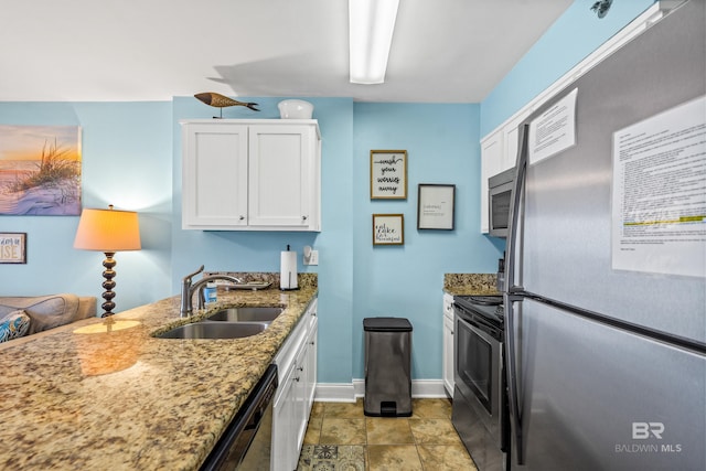 24568 Perdido Beach Blvd Unit 502, Orange Beach, AL 36561 - kitchen with appliances with stainless steel finishes, white cabinets, and light stone countertops