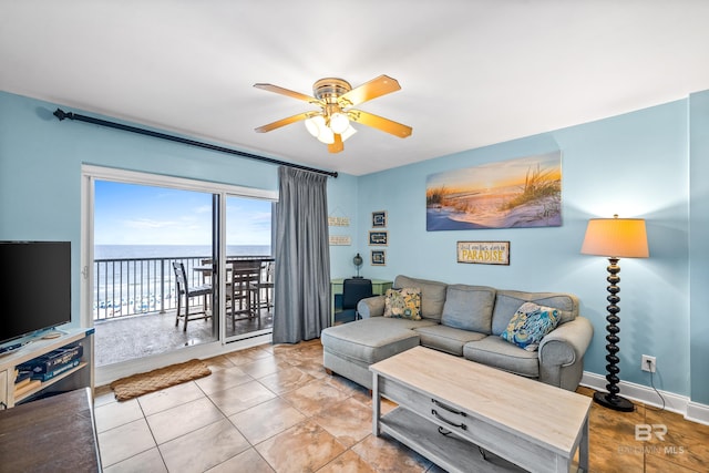 24568 Perdido Beach Blvd Unit 502, Orange Beach, AL 36561 - tiled living area with a ceiling fan and a water view