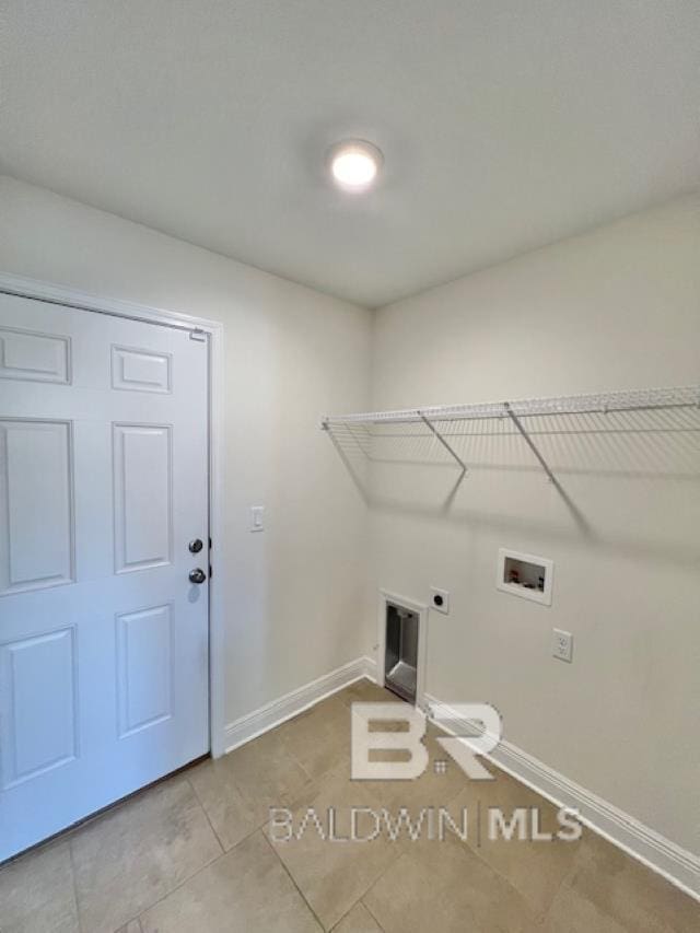 laundry area featuring washer hookup, electric dryer hookup, and light tile patterned floors