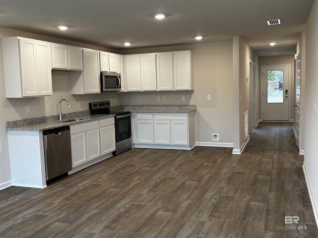 13710 Logan Pl, Foley, AL 36535 - kitchen with appliances with stainless steel finishes, a sink, light stone counters, white cabinets, and recessed lighting