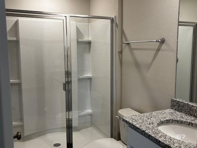 13710 Logan Pl, Foley, AL 36535 - bathroom featuring a textured wall, vanity, a shower stall, and toilet