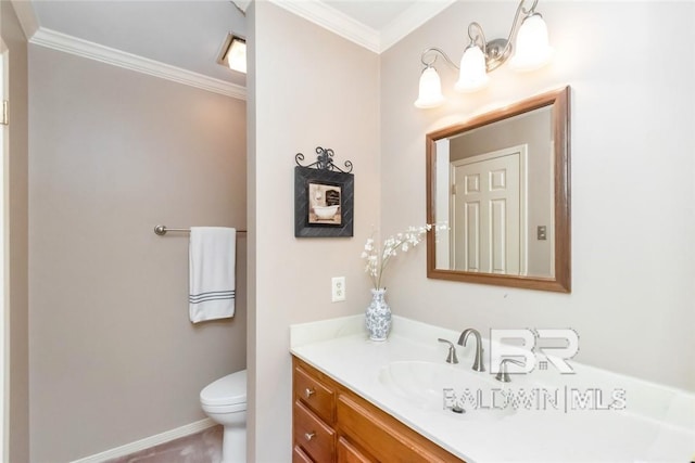 bathroom with toilet, ornamental molding, and vanity