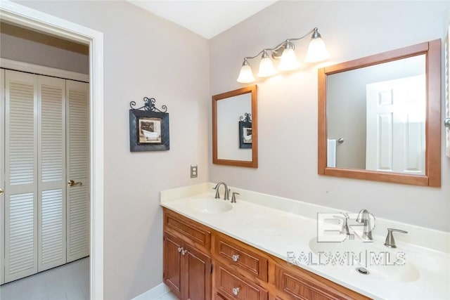 bathroom with dual vanity and tile patterned floors