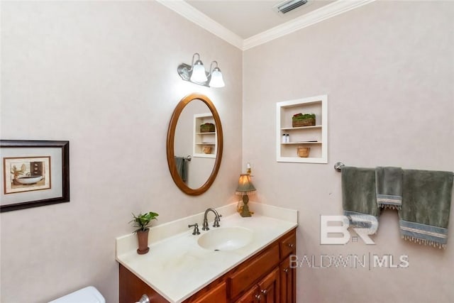 bathroom featuring crown molding and vanity