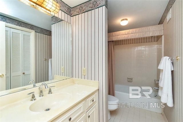 bathroom featuring tile patterned floors, vanity, and toilet