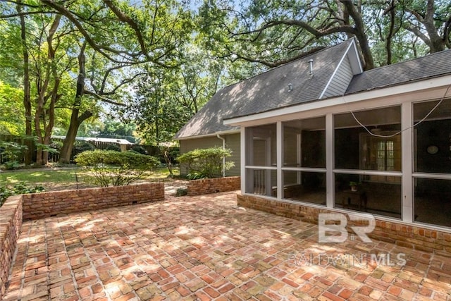 view of patio with a sunroom