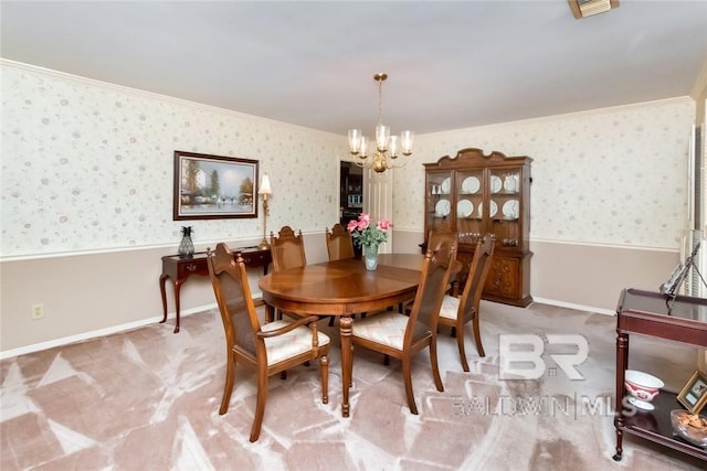 carpeted dining space with an inviting chandelier and ornamental molding