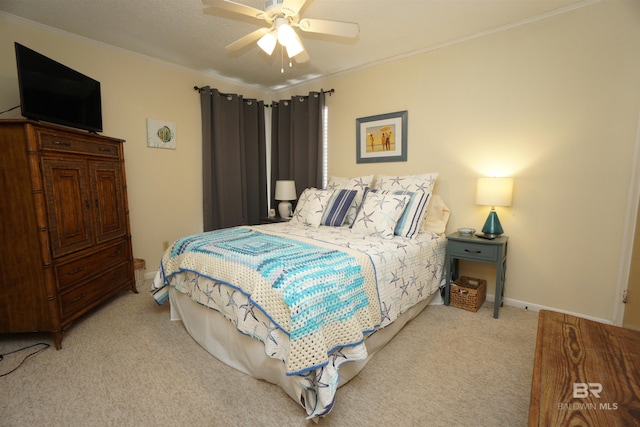 bedroom with baseboards, ornamental molding, a ceiling fan, and carpet