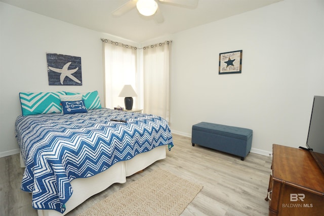 bedroom with baseboards, wood finished floors, and a ceiling fan