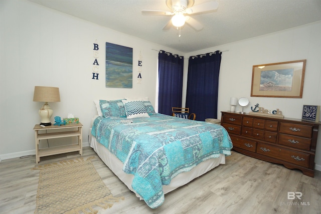 bedroom featuring wood finished floors, a ceiling fan, and ornamental molding