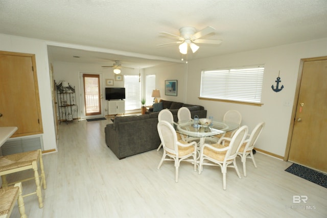 dining space featuring ceiling fan, wood finished floors, and baseboards