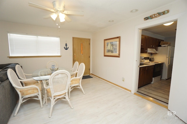 dining area with ceiling fan, baseboards, and light wood-type flooring