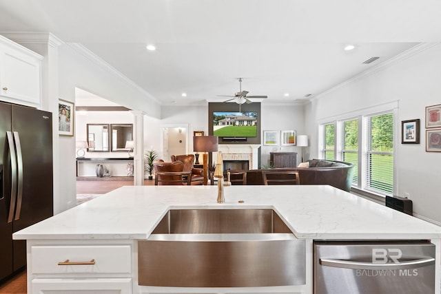 kitchen with ceiling fan, stainless steel appliances, crown molding, white cabinets, and hardwood / wood-style floors