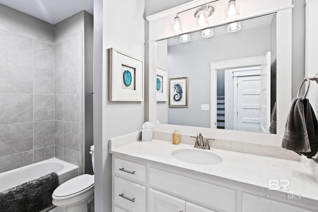 full bathroom featuring toilet, vanity, and tiled shower / bath