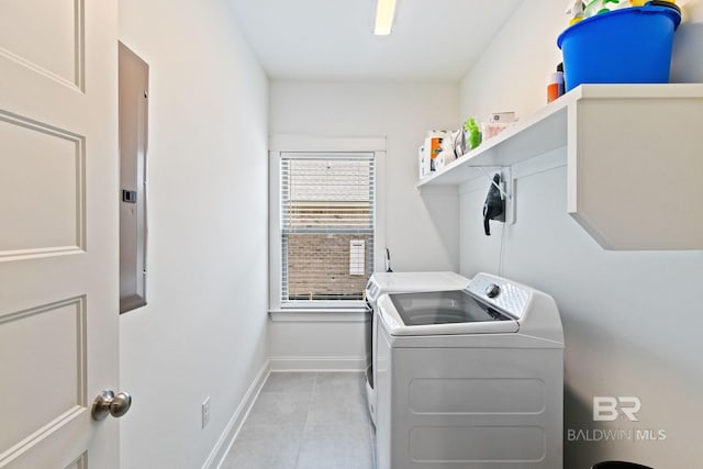 laundry room featuring washer and dryer and light tile patterned floors