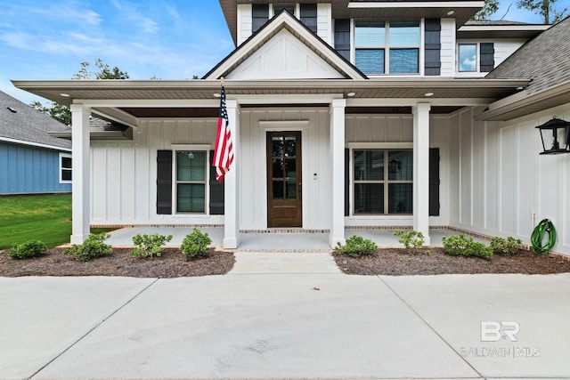 view of exterior entry featuring covered porch