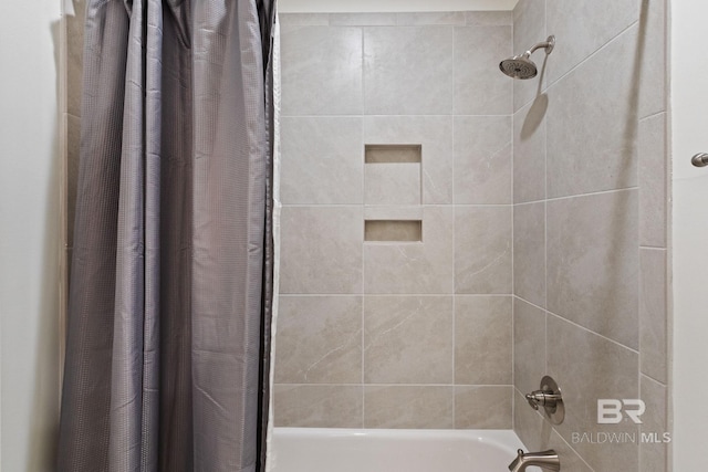 bathroom with shower / bath combo with shower curtain