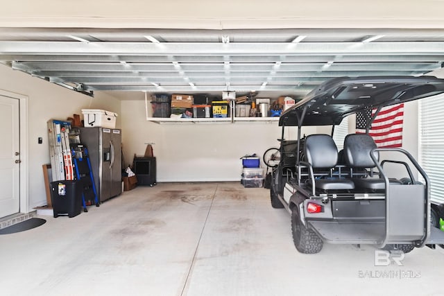 garage with stainless steel fridge