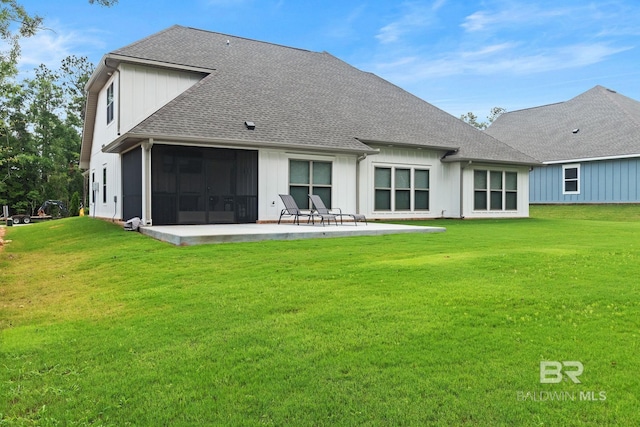 rear view of property with a yard and a patio