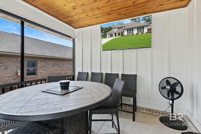 dining space with brick wall and wooden ceiling