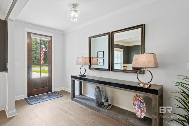 entrance foyer with hardwood / wood-style flooring and crown molding