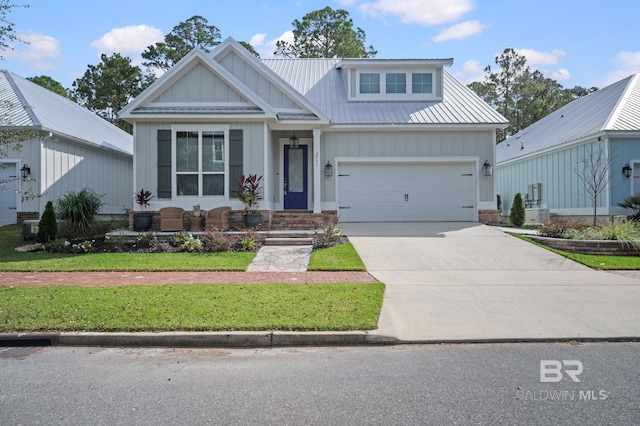 view of front of property with a garage and a front lawn