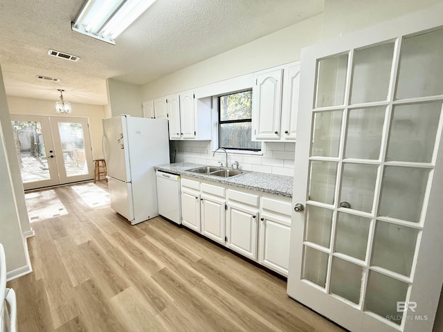 kitchen with white cabinetry, french doors, sink, pendant lighting, and white appliances