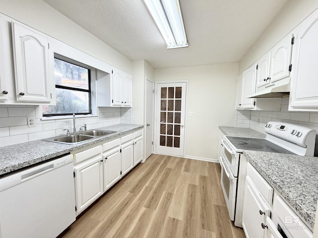 kitchen with stove, light wood-type flooring, white cabinets, sink, and dishwasher