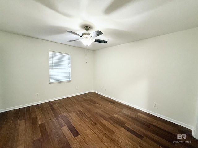 unfurnished room featuring ceiling fan and dark wood-type flooring