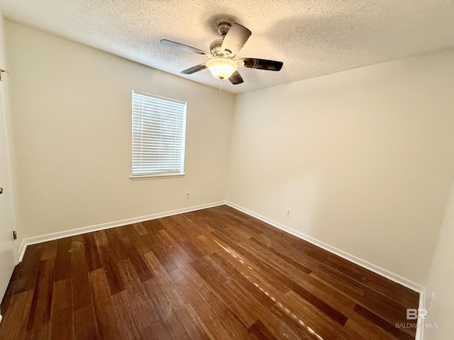 unfurnished room with ceiling fan, dark hardwood / wood-style flooring, and a textured ceiling