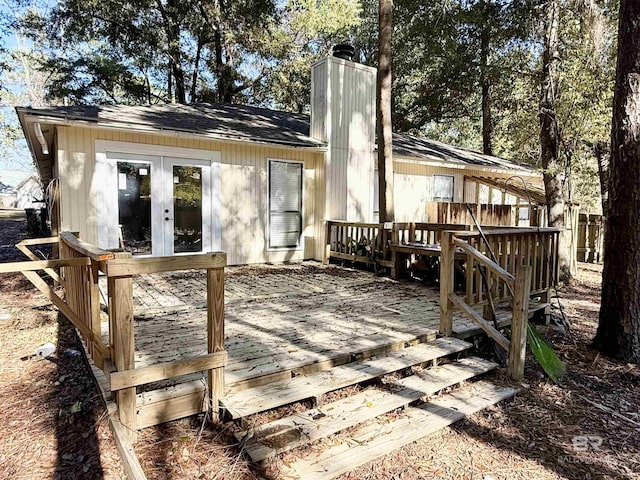 rear view of property with french doors and a wooden deck