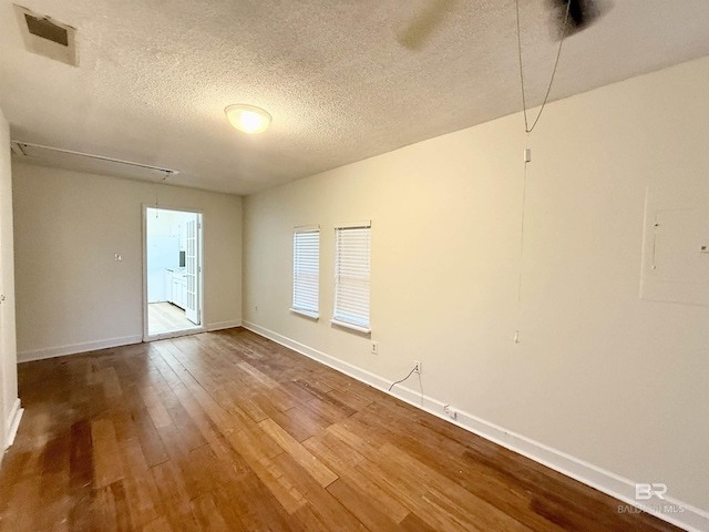 empty room featuring hardwood / wood-style floors and a textured ceiling