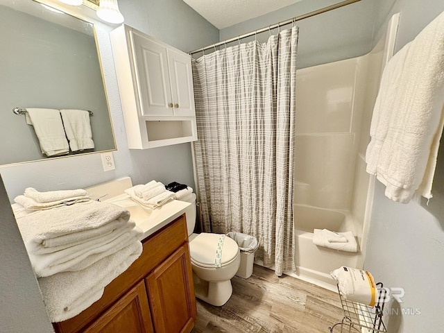 bathroom with shower / bath combination with curtain, vanity, toilet, and wood finished floors