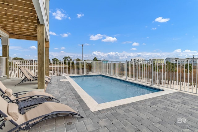 view of swimming pool with a patio area, fence, and a fenced in pool
