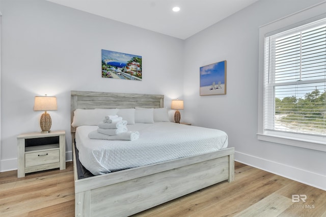 bedroom with recessed lighting, baseboards, and wood finished floors