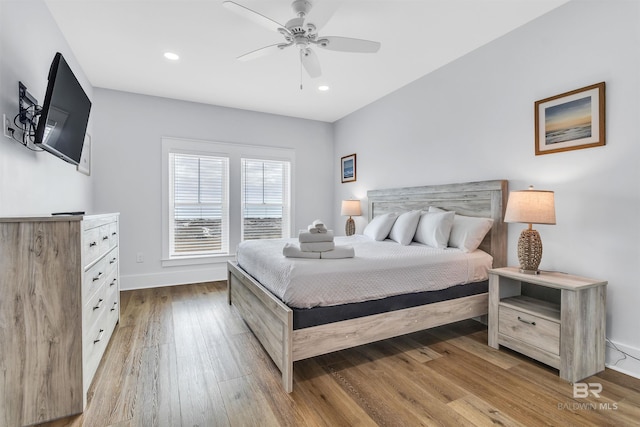 bedroom featuring a ceiling fan, baseboards, hardwood / wood-style floors, and recessed lighting