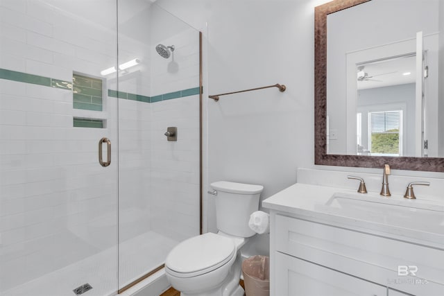 full bathroom with toilet, a shower stall, and vanity