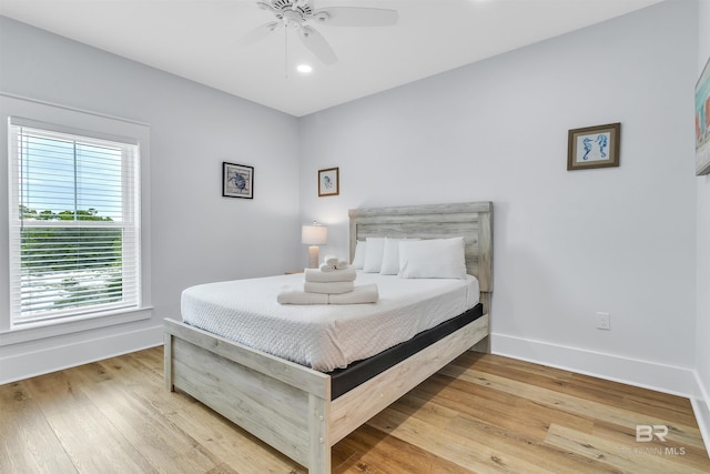 bedroom featuring light wood-style floors, ceiling fan, and baseboards
