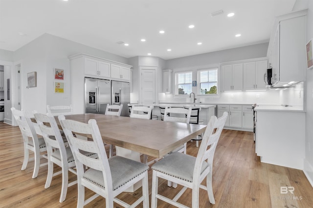 dining area featuring light wood-style floors, visible vents, and recessed lighting