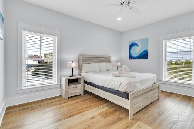 bedroom with ceiling fan, light wood finished floors, recessed lighting, and baseboards