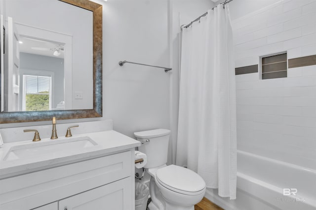 bathroom featuring shower / bathtub combination with curtain, toilet, and vanity
