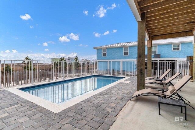 view of pool with a patio area, fence, and a fenced in pool