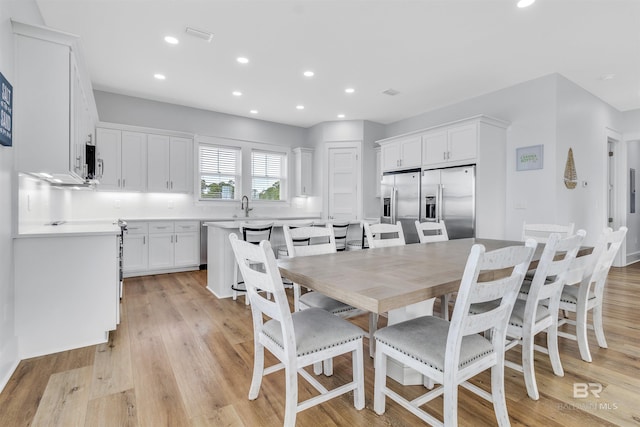 dining room featuring light wood-type flooring, visible vents, and recessed lighting
