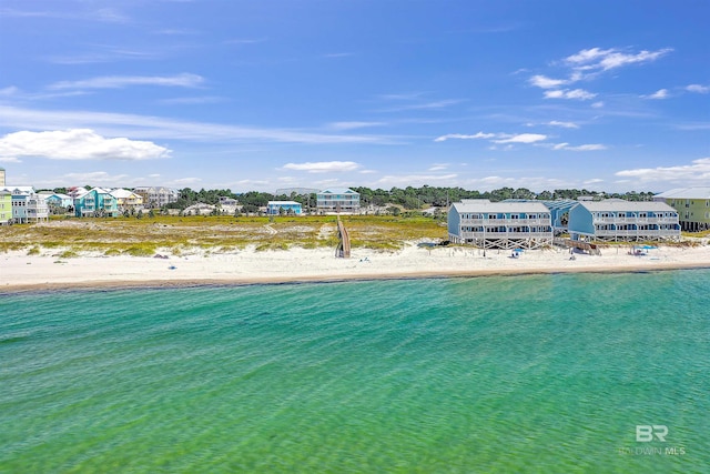 birds eye view of property featuring a water view and a view of the beach