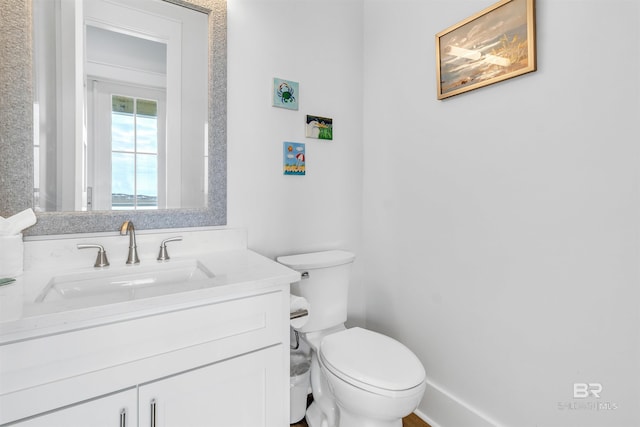 half bathroom with vanity and toilet