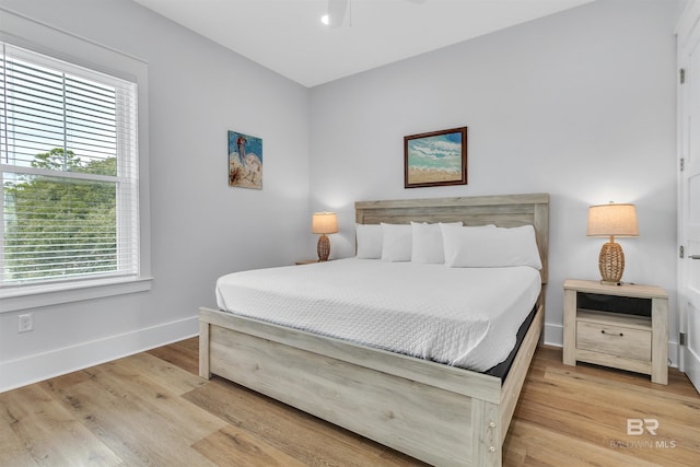 bedroom with wood finished floors and baseboards